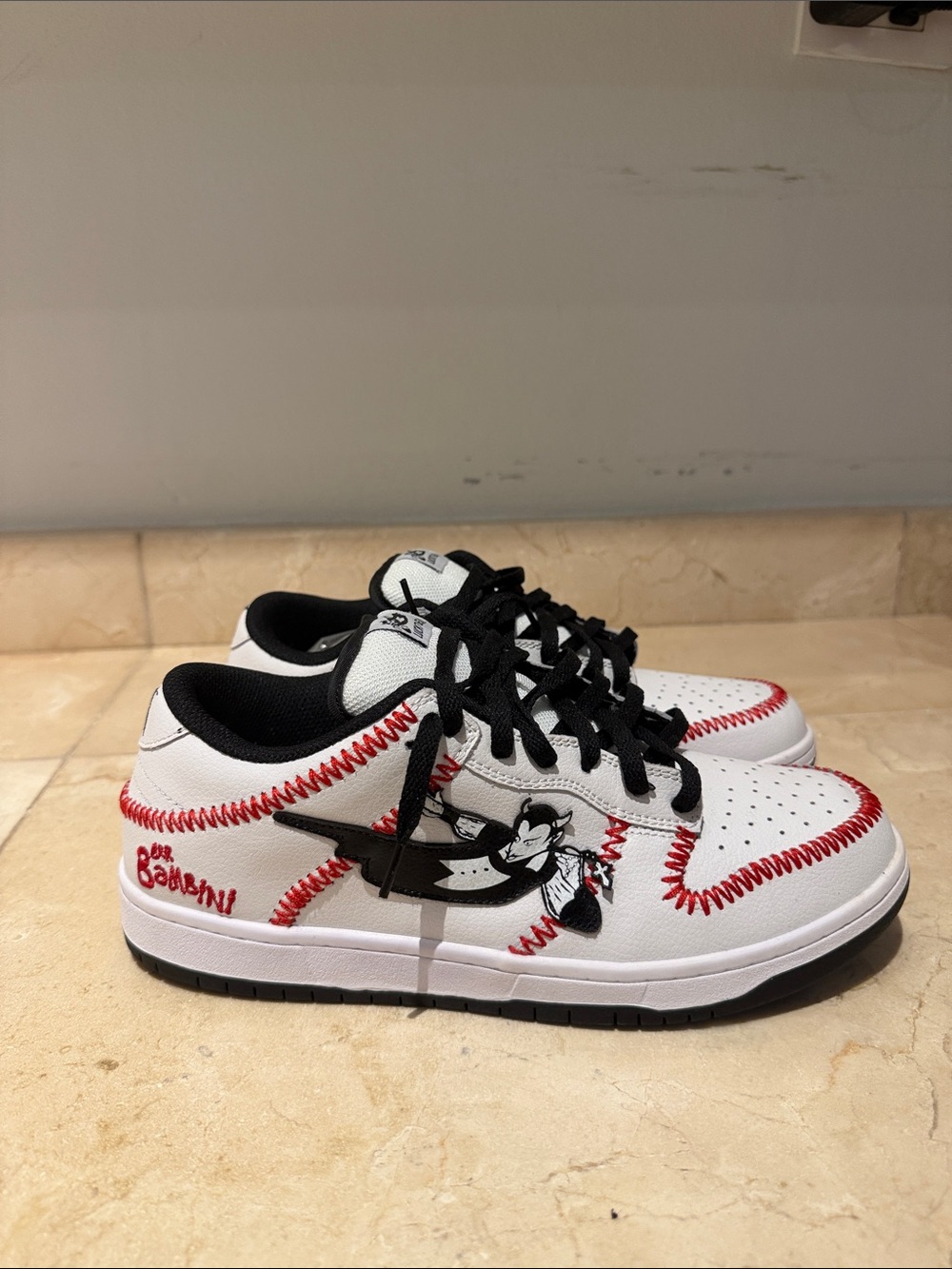 White and Black Sneakers with Red Baseball Stitch Detailing